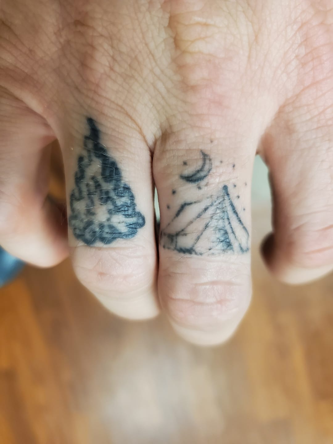 finger tent tattoo